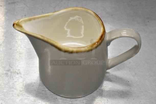 Acopa Keystone 10 oz. stoneware creamer in granite gray, features a handle and spout. New with minor imperfections.
