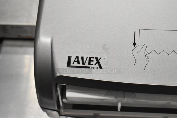 Lavex Poly Wall Mount Paper Towel Dispenser, new scratch and dent condition, silver, with pull-down instruction graphic.