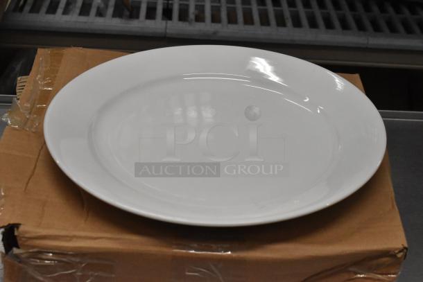 Oneida Buffalo Bright White Ware 12" Rolled Edge Porcelain Plate, new condition, on a cardboard box.