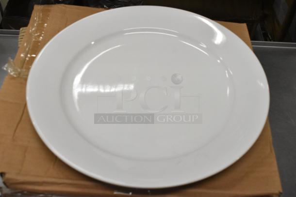 Brand new Oneida Buffalo Bright White Ware 12" porcelain plate with rolled edge, resting on cardboard packaging.