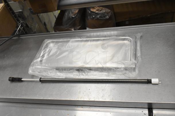 Brand new oven rack, wrapped in plastic, labeled as scratch and dent. Includes additional items. Auction for 4 times your bid.