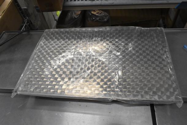 Bubble-wrapped oven rack, brand new with scratch and dent imperfections, part of a 4-item auction lot.