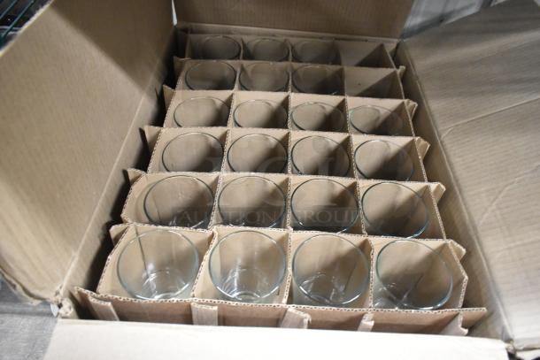 Box of brand new customizable pint and brandy glasses; Acopa and Libbey brands visible, packed in cardboard dividers.