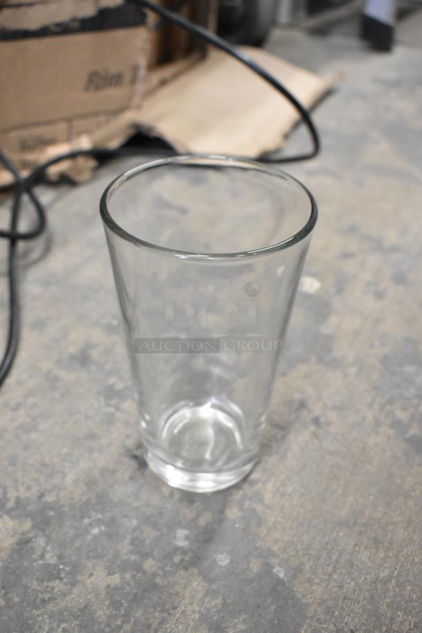 Clear Acopa 16 oz. customizable mixing glass; simple design, smooth finish. Part of scratch and dent set.