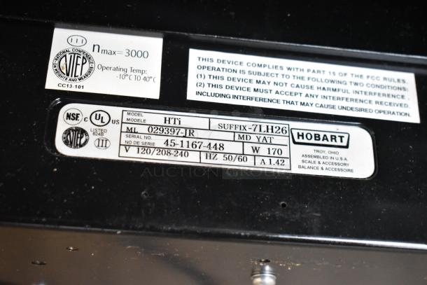 2017 Hobart HTi-7LH26 metal commercial countertop scale, 120/208-240 Volts, 1 Phase, model and serial labels visible.