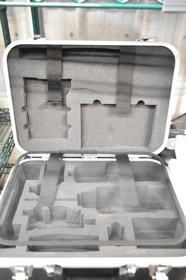 Open hard case with custom foam insert, black mesh cover, and secure straps. Used for equipment storage, good condition.