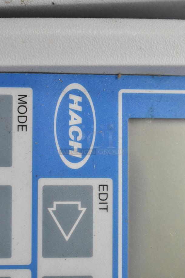 Close-up of Hach equipment control panel, showing mode and edit buttons. Part of a lot including Hach instruments.