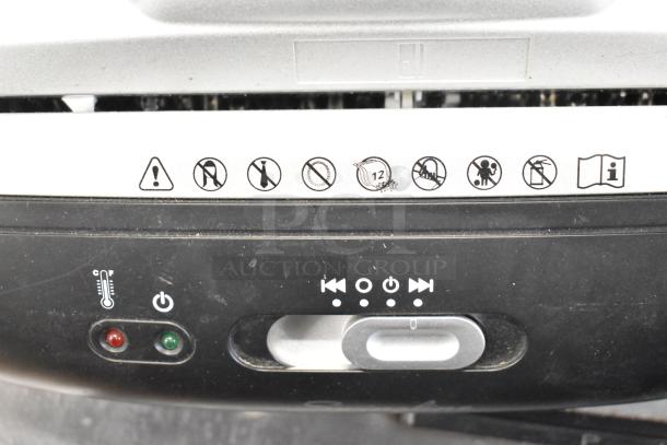Swingline paper shredder control panel with operation icons and power button, showing use instructions. Slight wear visible.