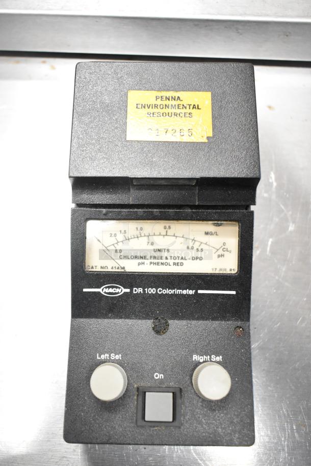 Hach DR100 Colorimeter, black, with controls and display. Used for water analysis. Marked "Penna. Environmental Resources."
