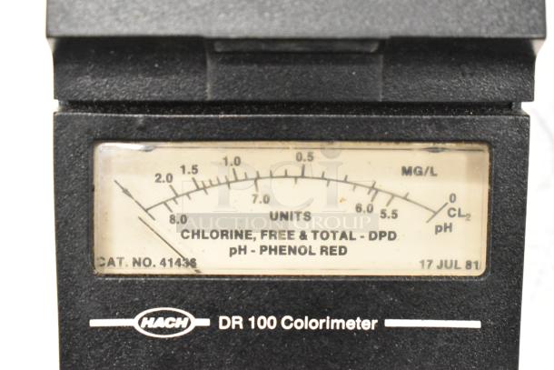 Hach DR100 Colorimeter front view, showing measurement scale for chlorine and pH levels. In used condition.