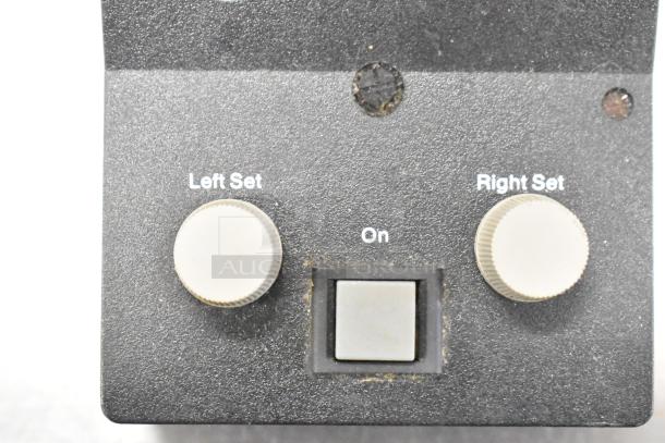 Black device panel with two control knobs labeled "Left Set" and "Right Set" and a central power button labeled "On."
