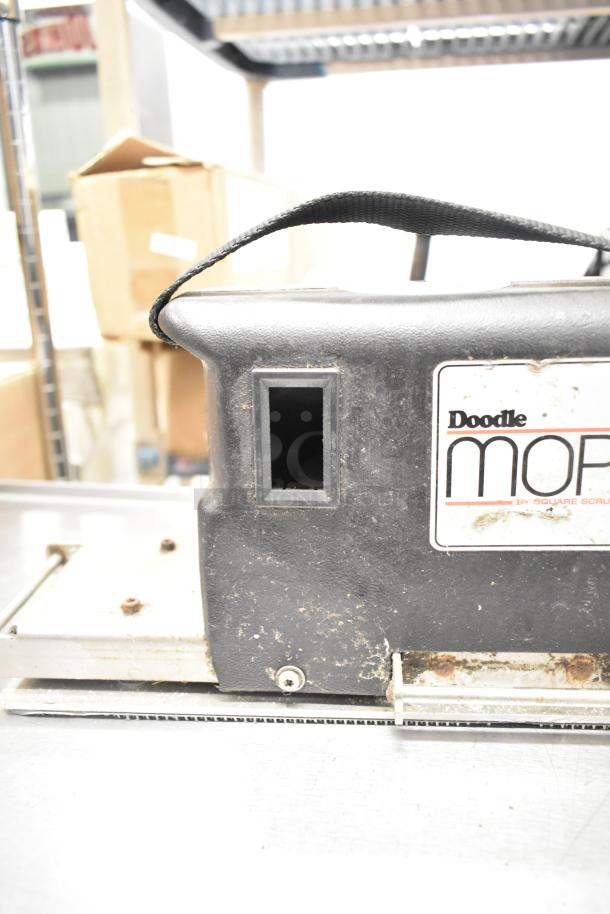 Doodlemop 36 VDC scrub battery in used condition, featuring a visible label. Ideal for industrial cleaning tasks.