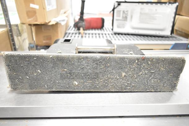 Doodlemop 36 VDC scrub battery with worn scrub pad, showing signs of use. Suitable for commercial cleaning equipment.