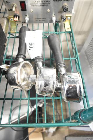 Three chrome portafilters with black handles, showing minor wear. Tag marked "109" is visible. Ideal for espresso machines.
