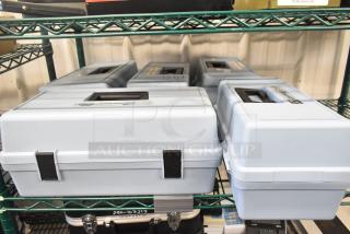 5 Hach 2100P Turbidimeter hard cases, empty, on a shelf. Light gray with locking clasps, durable design.