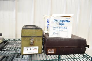 Four items including MLA pipette tips box, Leeds & Northrup specific ion meter in a metal case, and a brown briefcase.