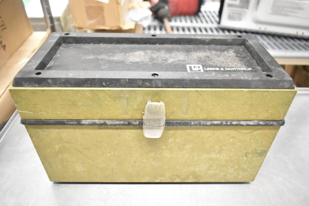 Leeds & Northrup specific ion meter box, used condition, green exterior, black handle, visible brand logo on lid.
