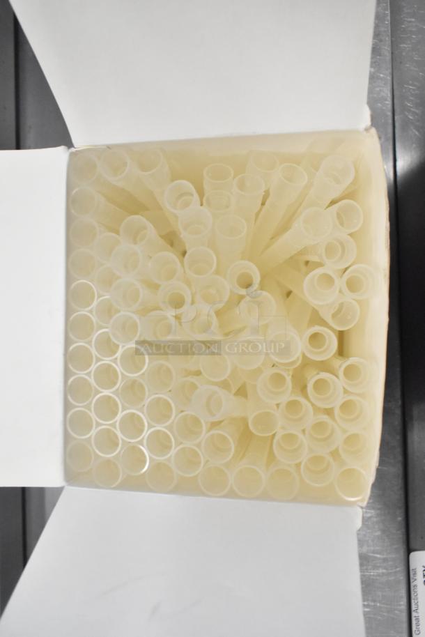 Box of clear pipette tips, neatly arranged. Suitable for laboratory use. New condition, essential for precise liquid handling.