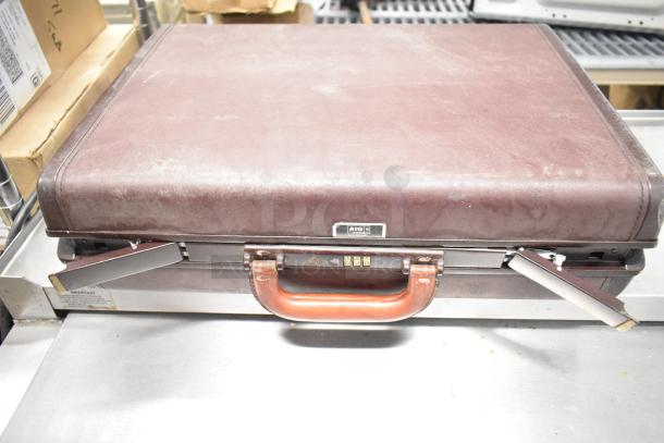 Brown briefcase with combination lock, worn condition. Part of a lot with pipette tips and Leeds & Northrup ion meter.