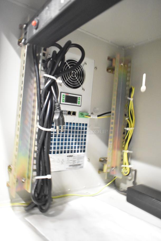 2 BlackShields DC0300 white metal air-conditioned technology cabinets, internal wiring and fan visible.