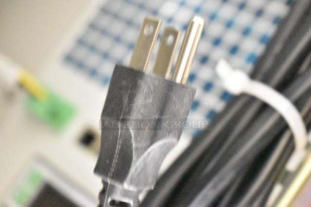 Close-up of power plug from BlackShields DC0300 technology cabinet, highlighting electrical connection. Auction includes 2 units.