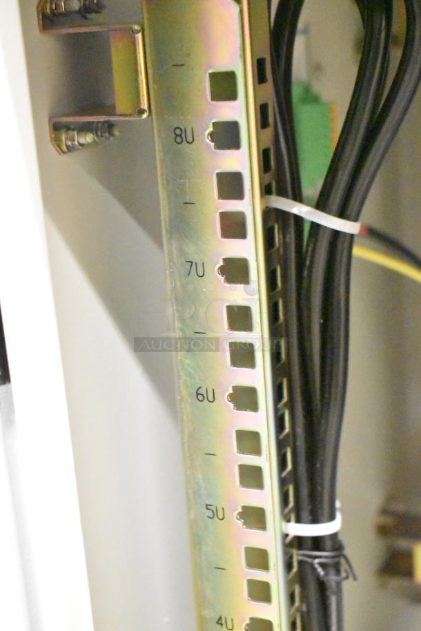 BlackShields DC0300 white metal cabinet interior showing rack units labeled 4U-8U, with wiring secured by a zip tie. No key included.