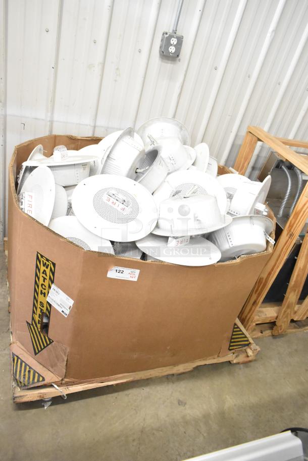 64 Wheelock CBB-8 speakers with fire alarm lights in a box. New condition. Auction item, bulk sale, tags visible.