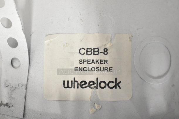 Wheelock CBB-8 speaker label on metal surface, marking indicates speaker enclosure. Item in used condition.