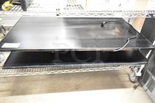 2 Samsung PM49H 49" displays, black, stacked on metal shelf. Includes power cords. Label reads "128." Condition appears used.