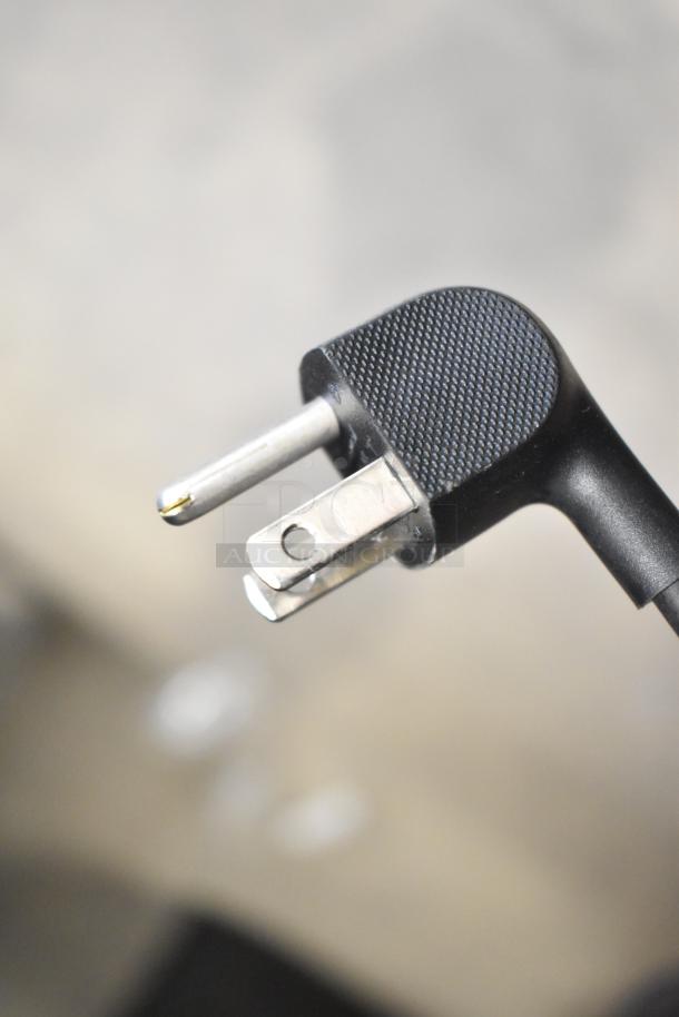 Black two-prong power plug reflecting overall condition of Samsung PM49H 49" color display television.