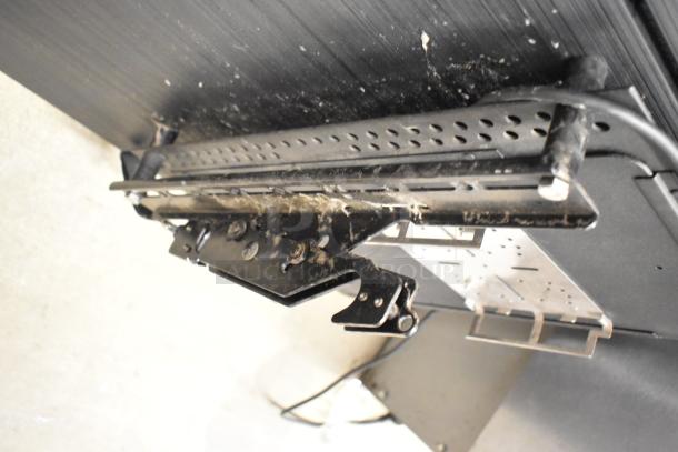 Ceiling-mounted bracket for Samsung PM49H 49" TVs, showing signs of wear and dust accumulation, no TVs visible.