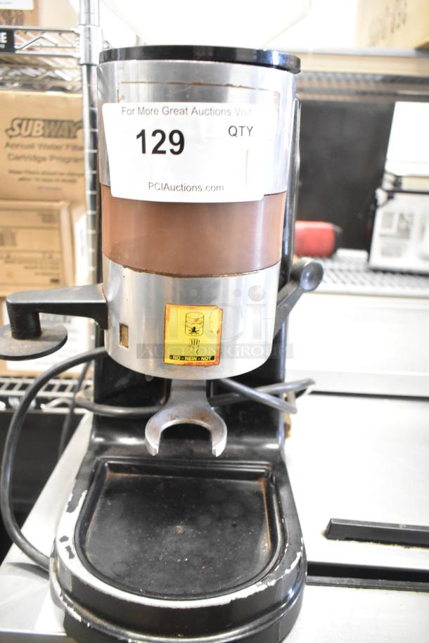 Metal commercial countertop espresso bean grinder, 115 volts, 1 phase, with markings. Slight wear visible.