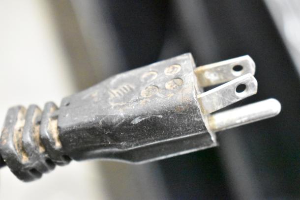 "Close-up of an electrical plug for a metal commercial countertop espresso bean grinder, 115 volts, 1 phase."