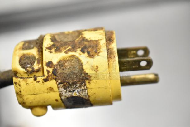 Close-up view of a rusty yellow plug for a Metal Commercial Countertop Espresso Bean Grinder, 115 volts, 1 phase.