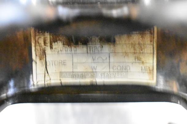 Label on commercial espresso bean grinder, indicating 115 Volts, 1 Phase, made in Italy. Worn condition.