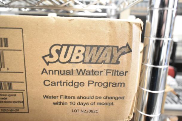 Cardboard box labeled "Subway Annual Water Filter Cartridge Program," showing minor dents, for 3M water filtration cartridges.