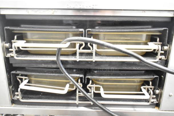 Prince Castle DHB-DDB stainless steel countertop holding bin, 120 volts, 1 phase, features four heating trays with rack handles.