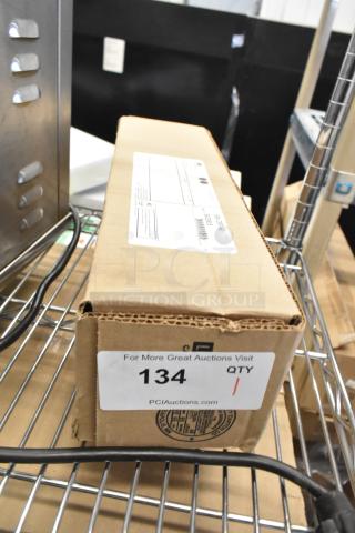 Brand new 3M SW-CRF-60 water filtration cartridge box on shelf with auction tag marked "134".