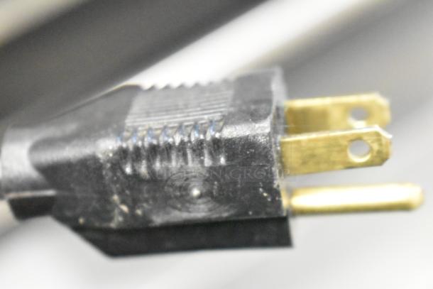 A close-up of a power plug for the Hoshizaki F-330BAH-C ice maker, highlighting its two-prong design.