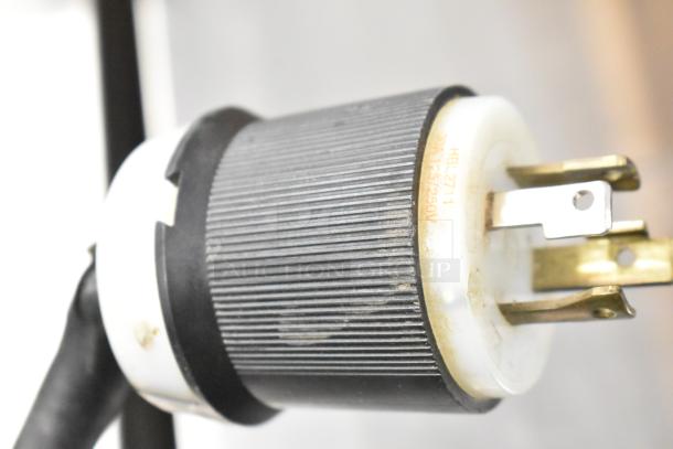 Close-up of a plug for Bunn IMIX-5 cappuccino machine, showing HBL 2711 marking, 30A, 125/250V.