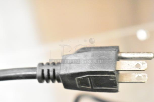 Close-up of a power plug for KoolMore SD105B cooler, 115 volts, 1 phase. Black plastic and metal prongs.