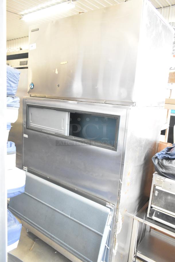 Hoshizaki KM-1300SRH commercial ice head on ice bin. Stainless steel, 208-230V, 1 Phase. Some wear visible.
