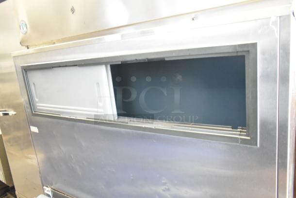 Hoshizaki KM-1300SRH stainless steel commercial ice head on bin, 208-230V, 1 phase. Visible scratches, open ice bin.