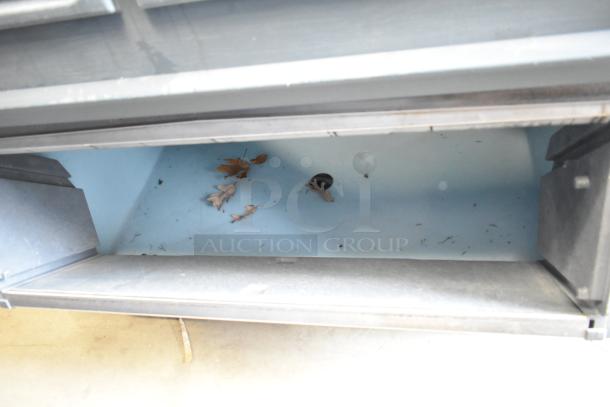 Hoshizaki KM-1300SRH commercial ice head and bin, stainless steel, 208-230V, 1 phase, interior view with debris.