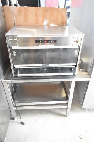 Hatco GRMW-3 Glo-Ray stainless steel warming display merchandiser. 120V, 1 phase, on an equipment stand.