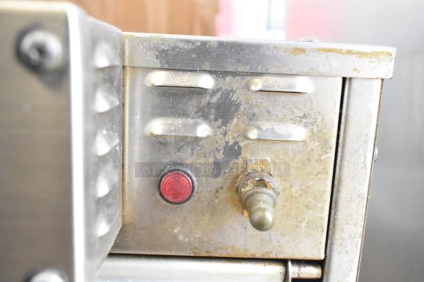 Hatco GRMW-3 Glo-Ray stainless steel warmer, red button, power switch; worn surface, on equipment stand. 120V, 1 Phase.