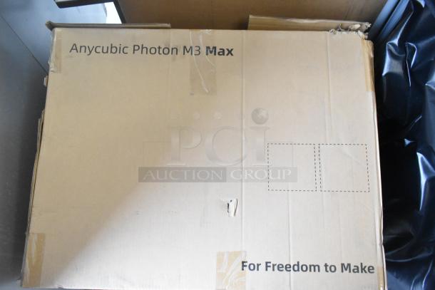 New Anycubic Photon M3 Max 3D Printer in a box, slight scratch and dent visible. Box labeled "For Freedom to Make."