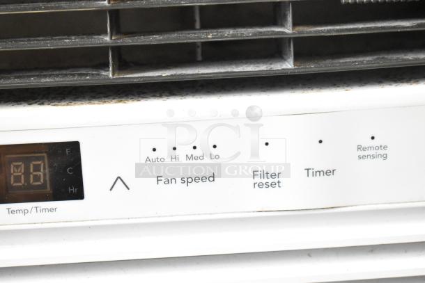 Electrolux FFRE1033U1 window air conditioner, 115V, panel showing fan speed, filter reset, timer, and remote sensing features.