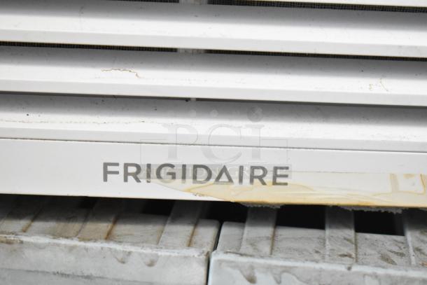 Electrolux FFRE1033U1 window air conditioner, white, visible wear on front grille. 115V, 1 phase. Frigidaire branding shown.