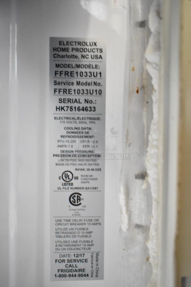 Electrolux FFRE1033U1 window air conditioner label, 115 volts, 1 phase, BTU 10,200, model and serial numbers visible.
